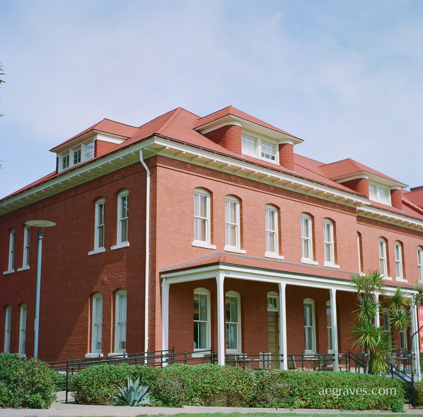 Sunlit brick red building with a patio at the Presidio of San Francisco Main Post