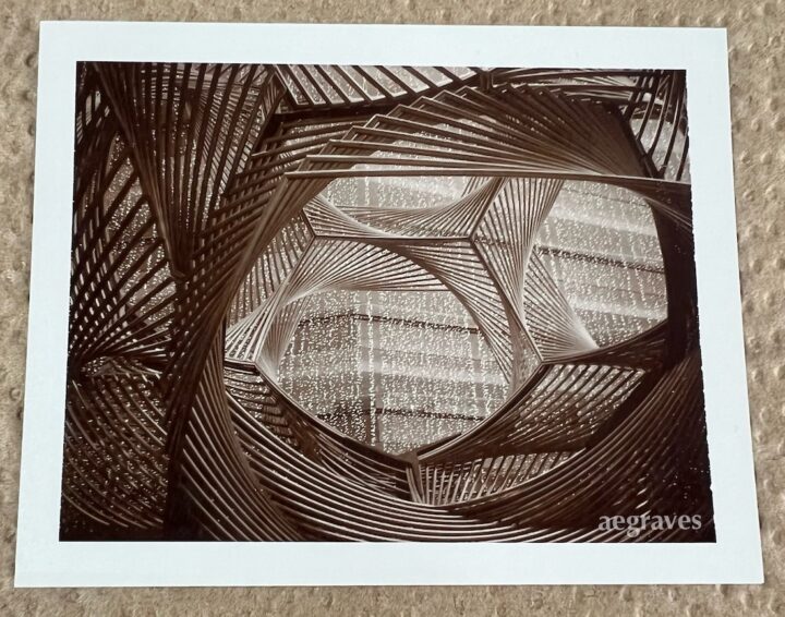 Sepia medium format photograph of portion of geometric sculpture in geometrically complex space