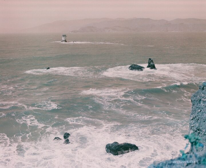 San Francisco's Lands End view in pale orange and teal of the coastal site of multiple shipwrecks