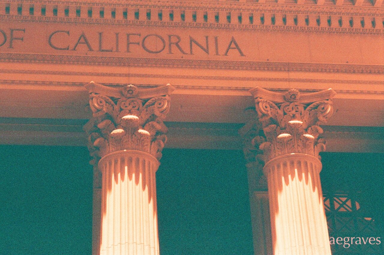 Orange and green image of corinthian columns at the Bank of California