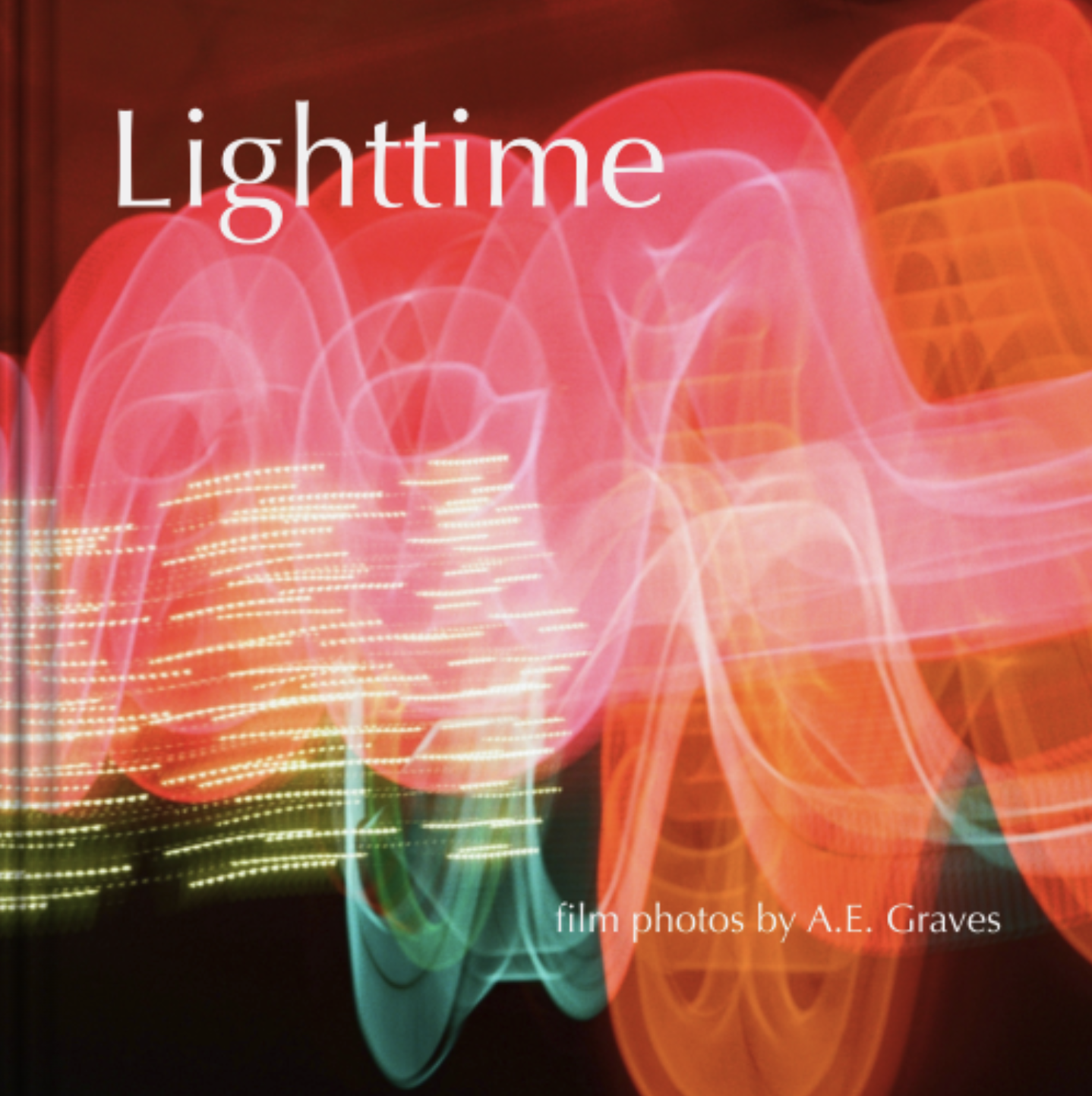 Cover of the photo book Lighttime by A.E. Graves; hardcover with abstract red, pink gold, and green pattern on a dark background