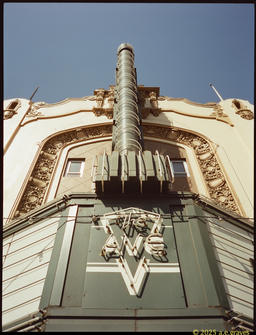 Ave - a close up of the front-facing panel below the marquee with neon reading The Ave