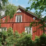 A festively red Swedish wooden building Iron red triangle