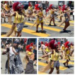 Samba Rio's group with vivid red wigs, yellow dresses, and zebra-print sashes dancing down the street with drumsticks
