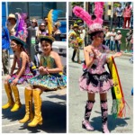 Two girls on the back of a truck and one woman standing, all in elaborately colorful costumes and feathered hats