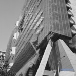 Black and white image of supports and the sun shining through screens on the east facade at the San Francisco Federal Building by Morphosis