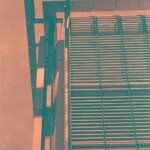 Orange and green image of a louvered facade