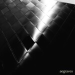 Deep blacks with nuance. Monochrome image of reflections on a matte metal tiled surface