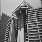 Monochrome image of the Hyatt Regency SF's rotating restaurant and its long shadow.