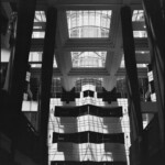 Monochrome image of an atrium with tall, dark columns