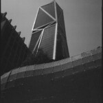 Monochrome images of several different structures, including a geometric skyscraper, a building in shade, and a metal screen